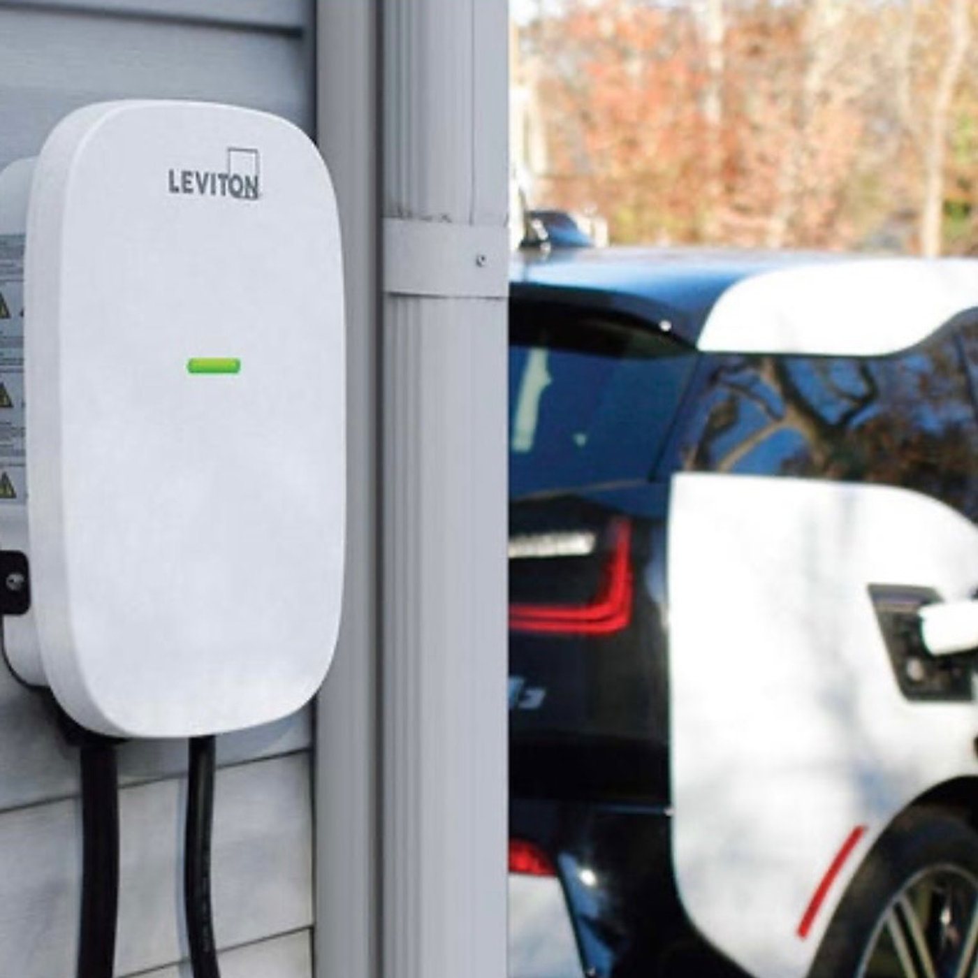 Home EV charger next to a vehicle